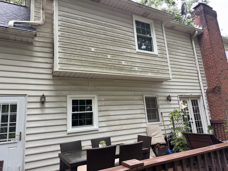 Mildew removed from siding before cleaning