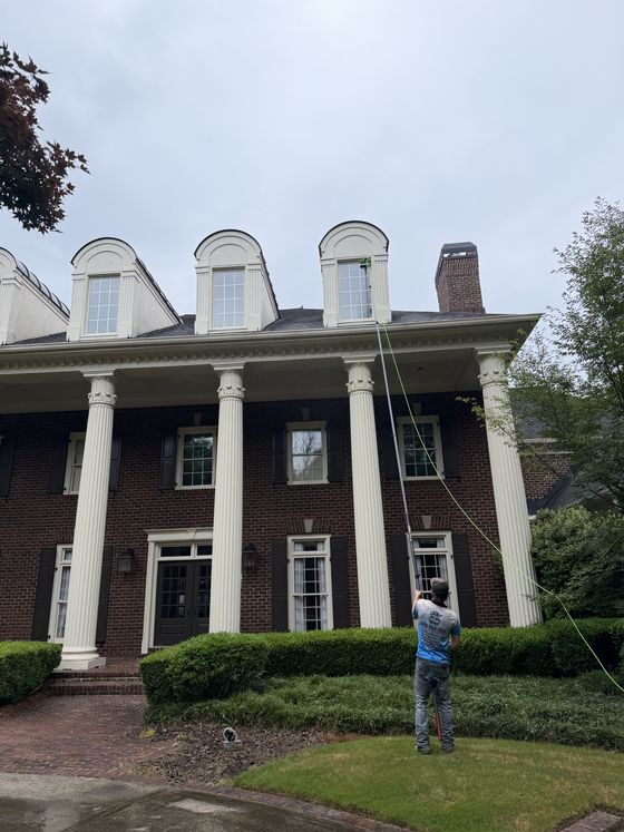 Window cleaning on a brick colonial home